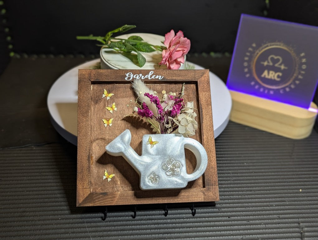 Hanging keys plaque with watering can with flowers and butterfly's